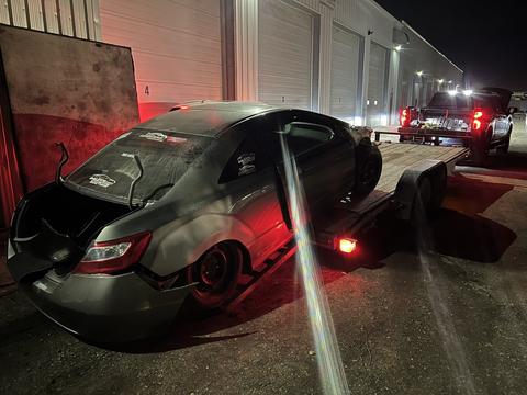 Nighttime Scrap Car Loading at Recycling Facility