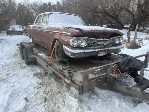 Vintage Car on Trailer for Scrap Metal Recycling in Snowy Yard